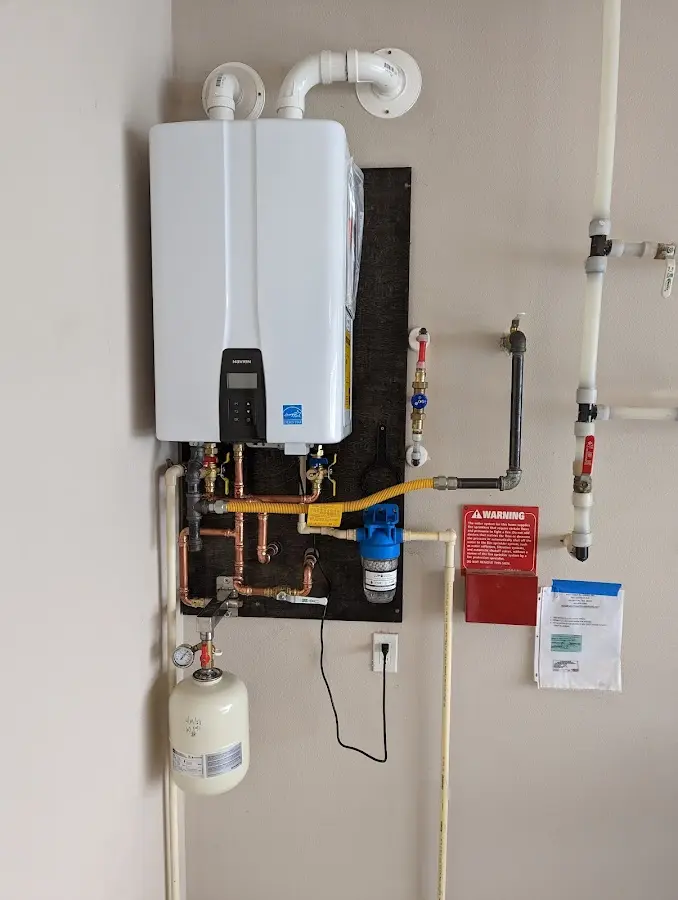 Professional plumber installing copper piping in a Peoria Heights home